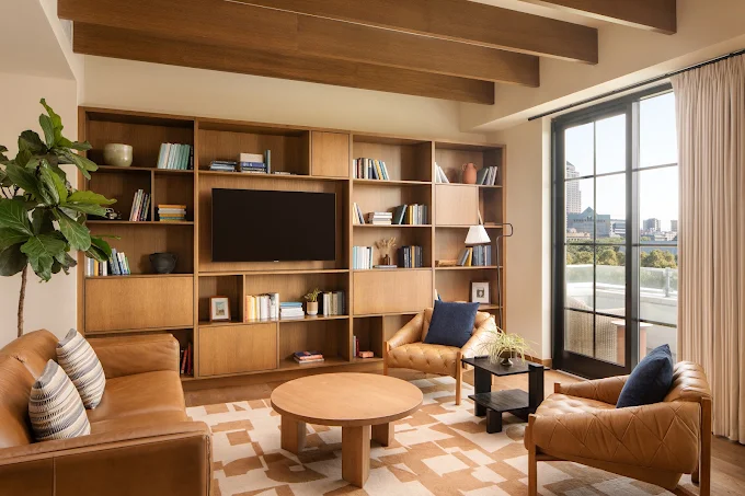 A suite living room at The Junto, with a built in library wall and access to a private terrace. 
