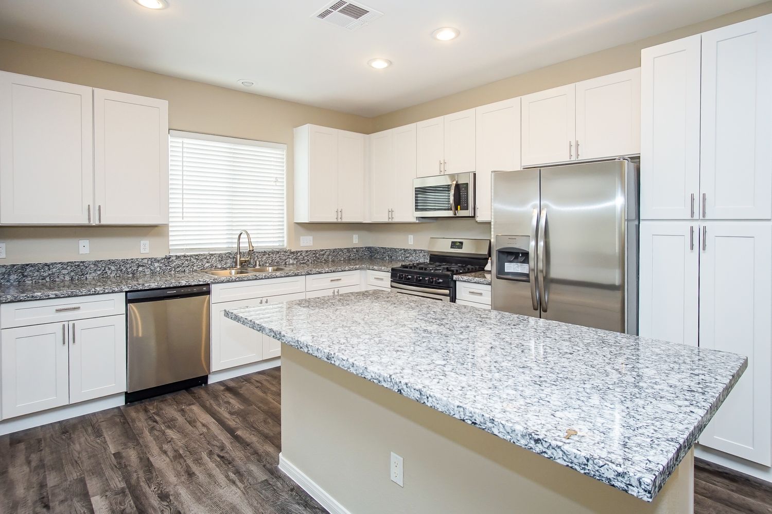 gorgeous kitchen in Las Vegas equipped with stainless steel appliances and granite countertops by Invitation Homes