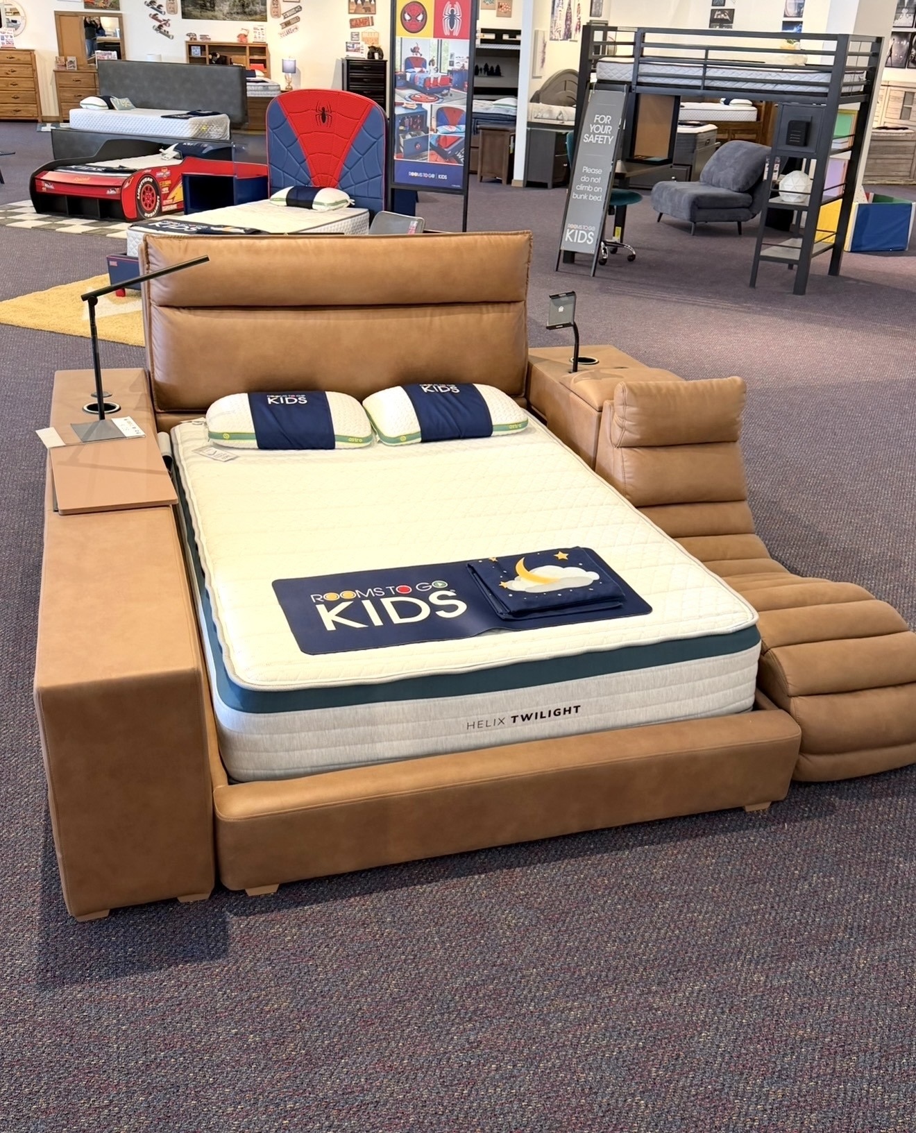 Tan leather upholstered bed with attached chaise lounge seating.