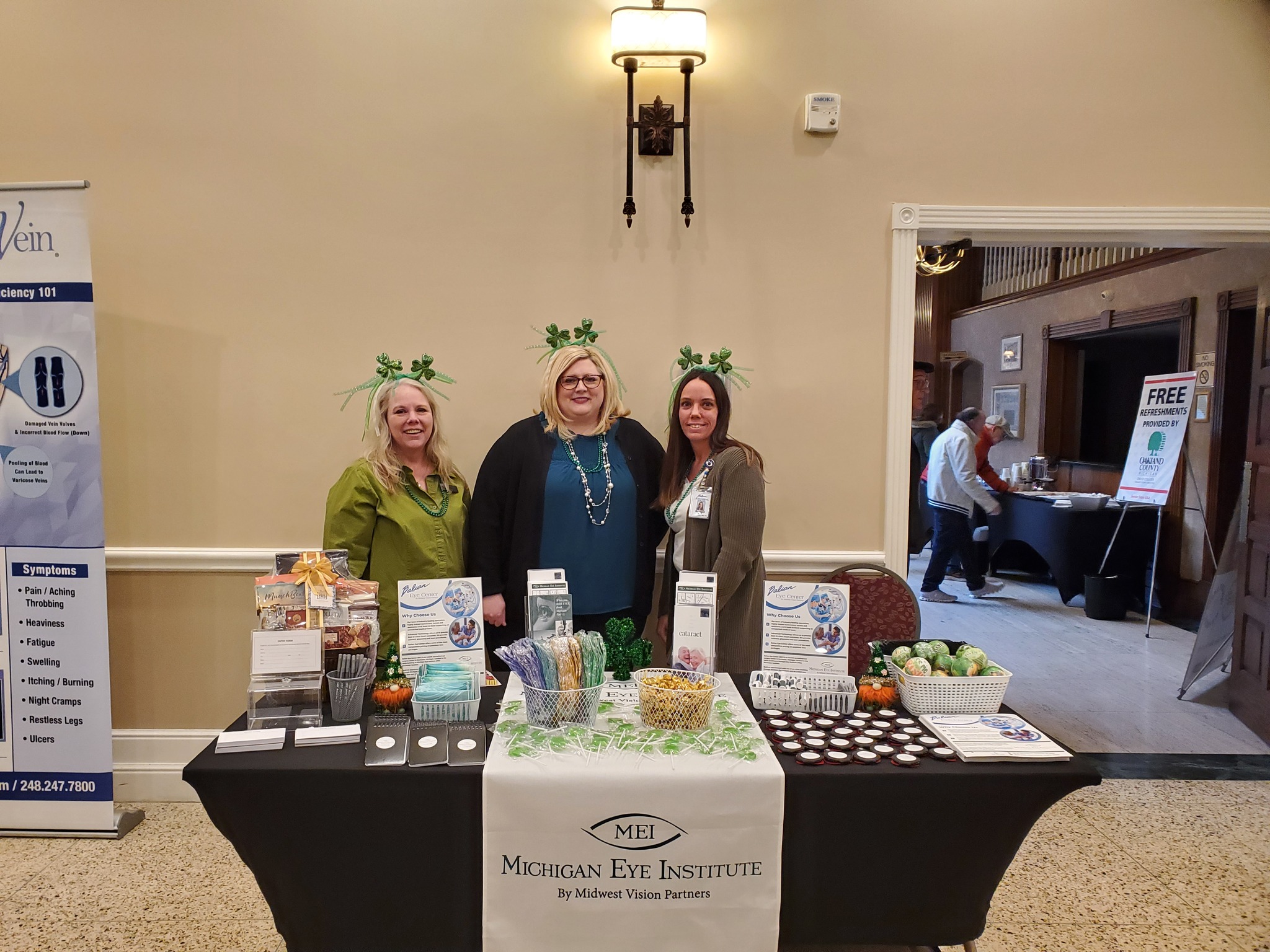 Michigan Eye Institute Employees Standing Behind a Booth