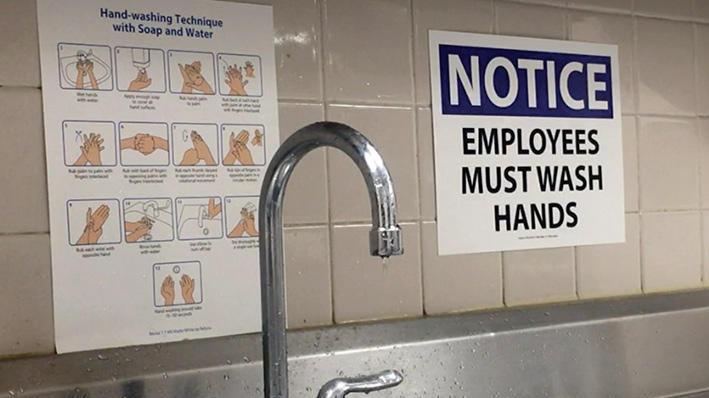 Safety and hygiene posters next to a sink