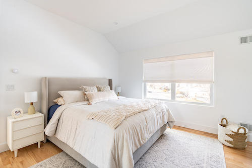 Shutters serve as a natural filter in this quaint reading nook,  diffusing the sunlight just enough to create a calming atmosphere. Wood shutters elevate any room, and are easy to operate with their cordless design!