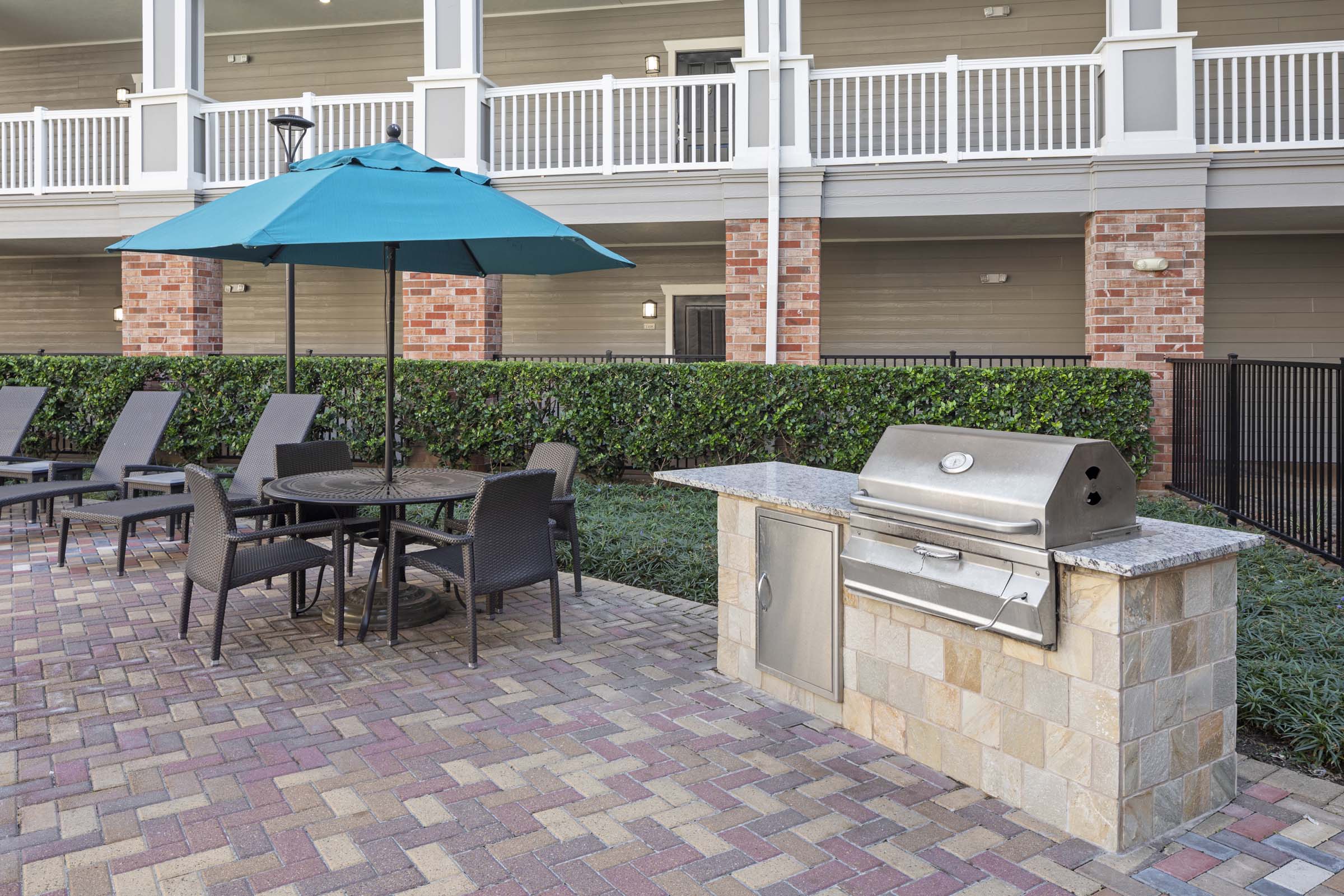 Outdoor grilling by the resort-style pool with dining at Camden Heights Apartments in Houston, Tx