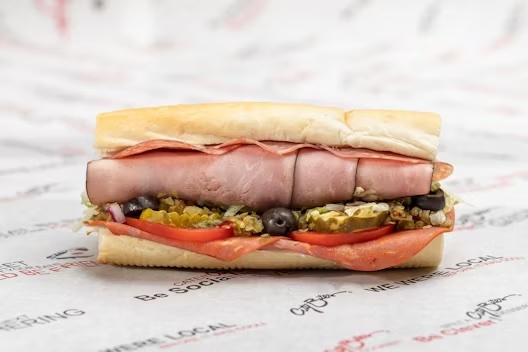 Ham, salami, capocollo, provolone, lettuce, tomatoes, red onions, pickles, black olives, crushed cherry peppers, blended oils, mayo, salt & pepper.