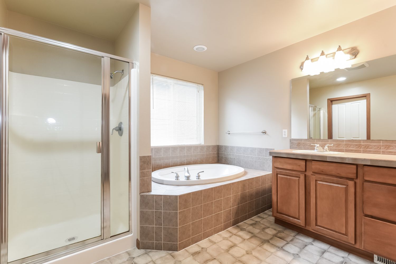 Master bathroom with shower and tub at Invitation Homes Seattle.