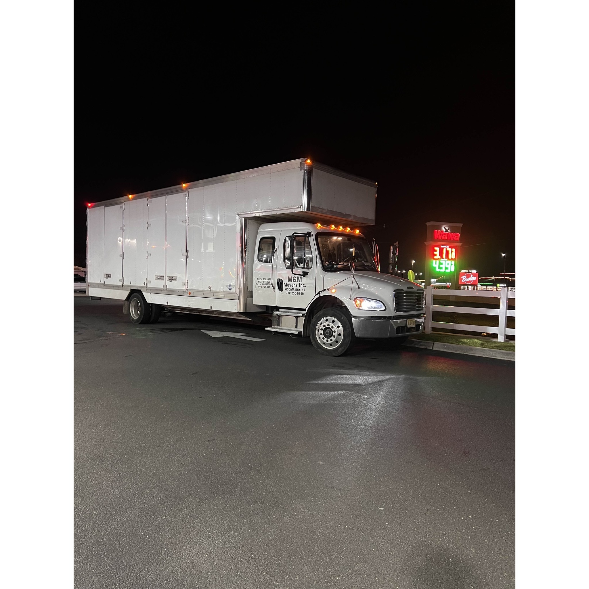 M&M Movers box truck parked at night, highlighting the company fleet ready for after-hours pickups and long-distance moving runs.