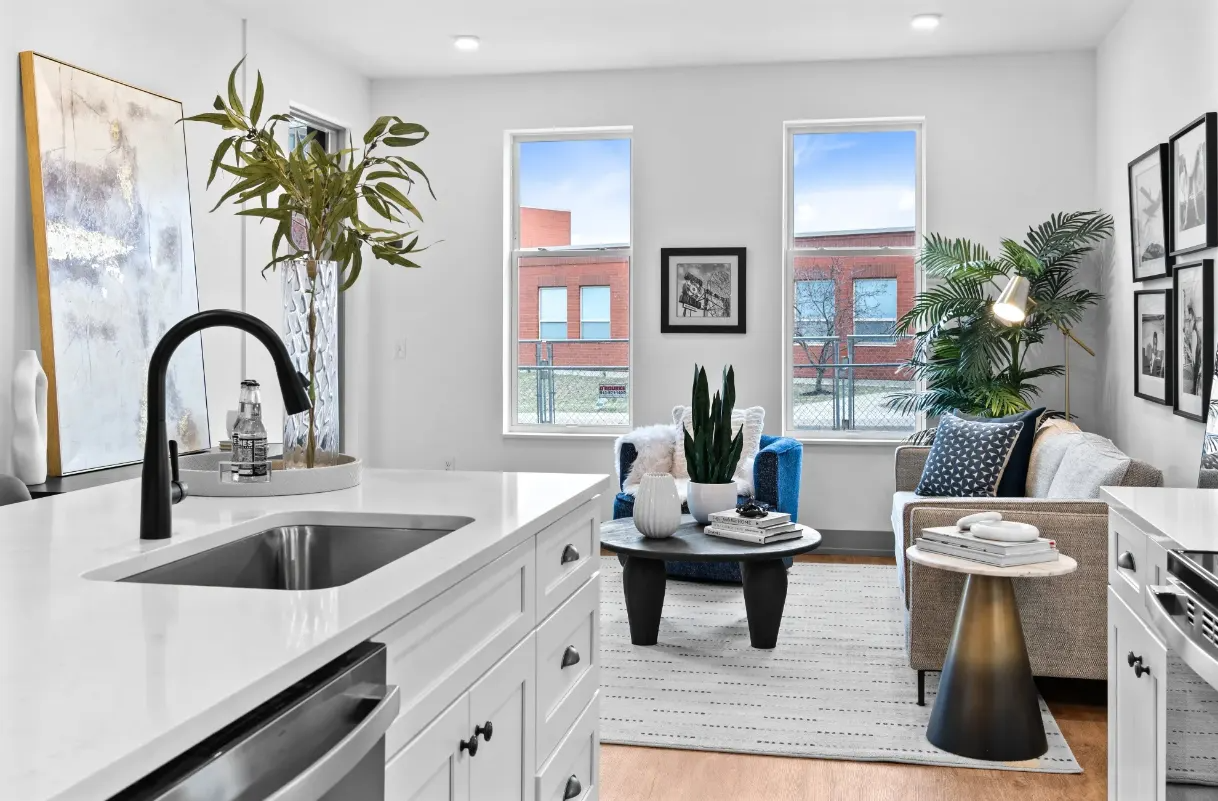 A modern kitchen with a large island and a dining area. 