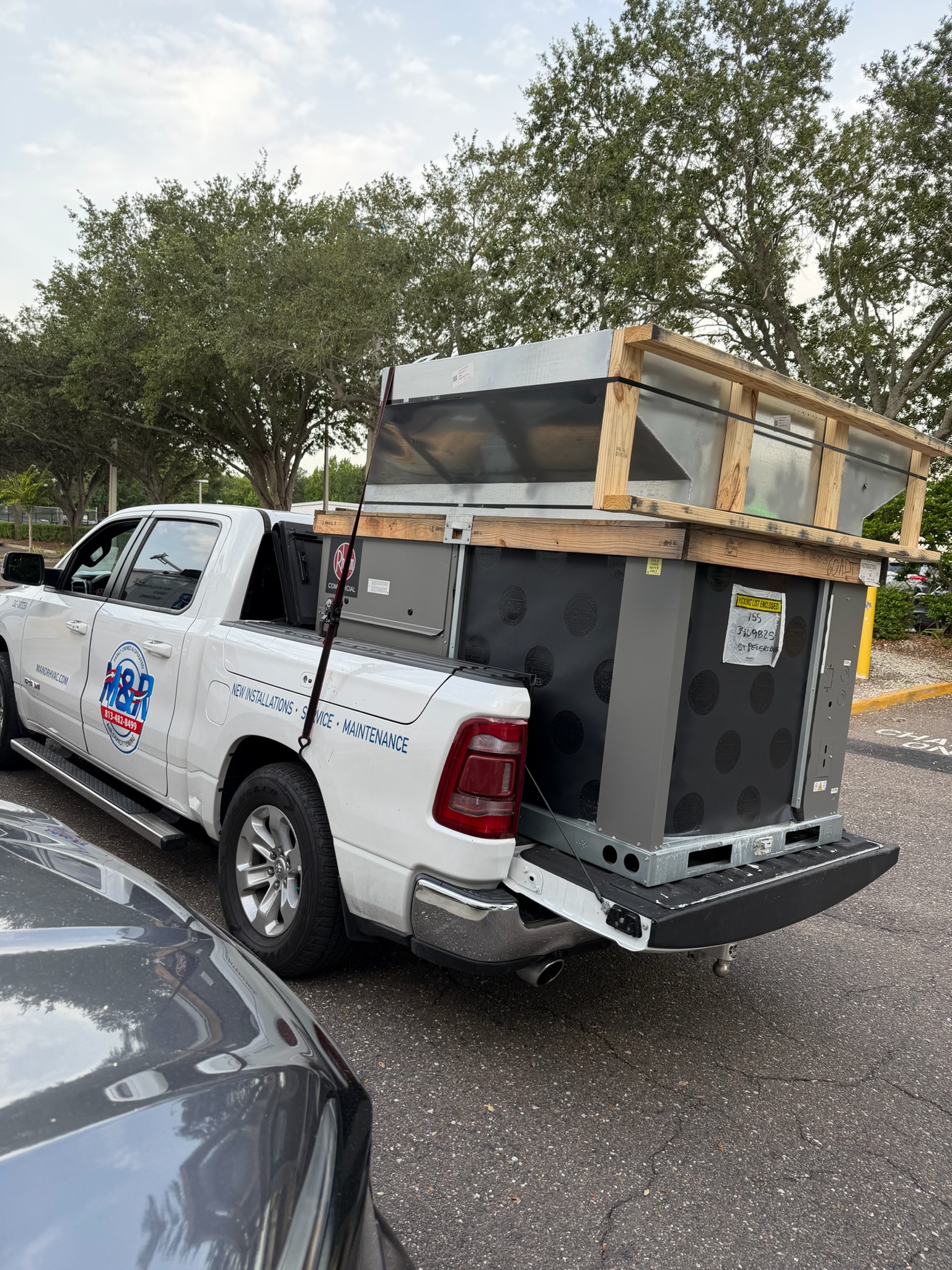 M&R Air Conditioning service vehicle carrying HVAC equipment and tools for an installation or repair 