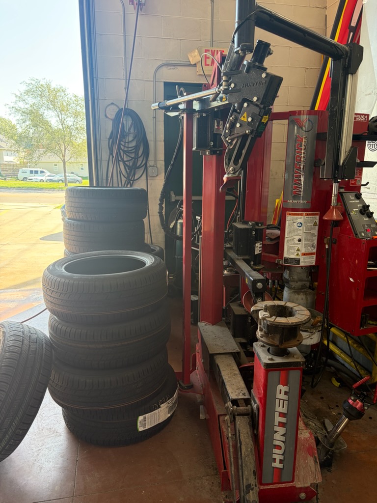 Tire service equipment and tires inside Walker Tire Point S at 48th & Pioneer in Lincoln.