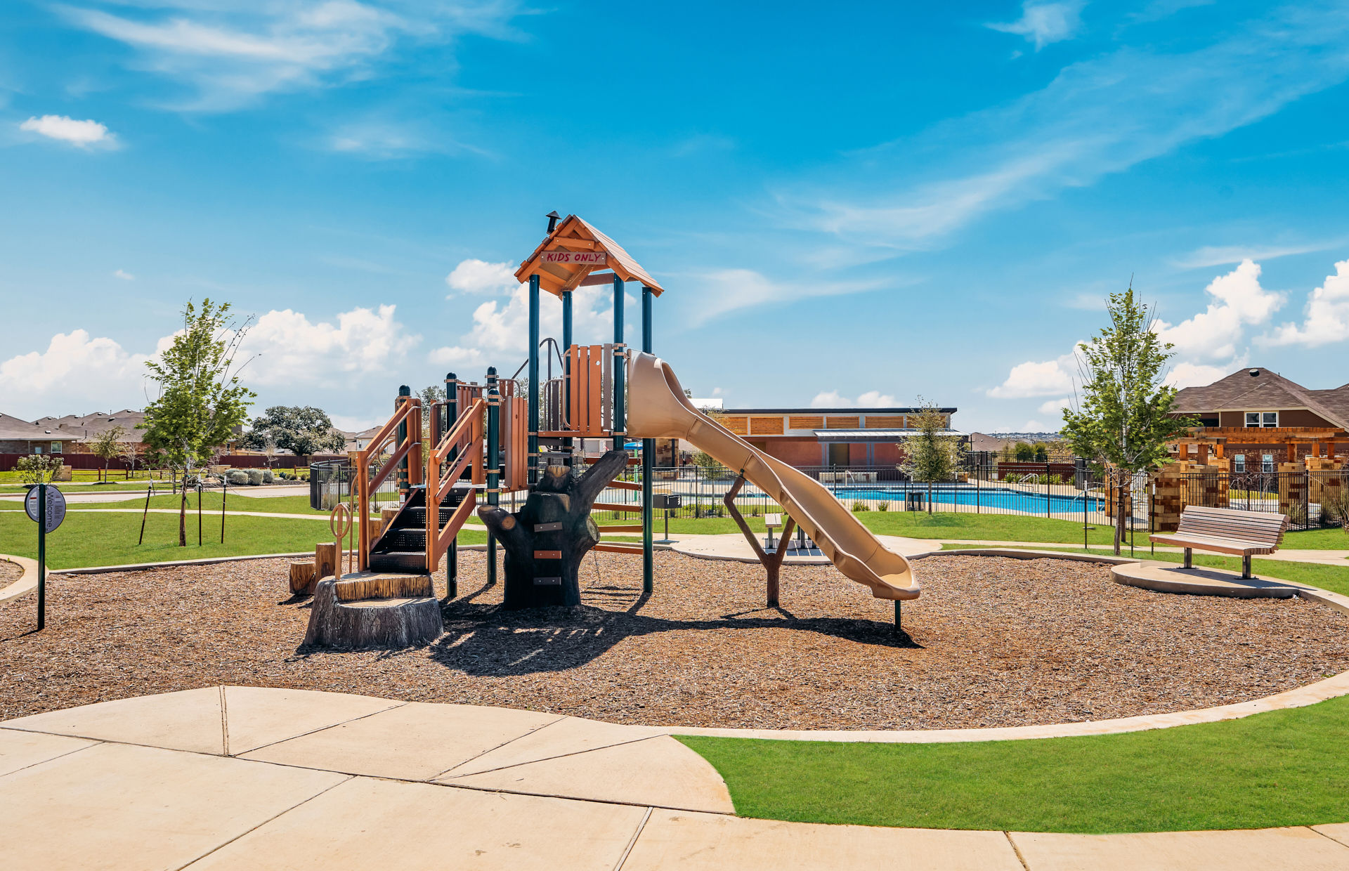 Community playground next to pool and new homes at Davis Ranch community in San Antonio, Texas
