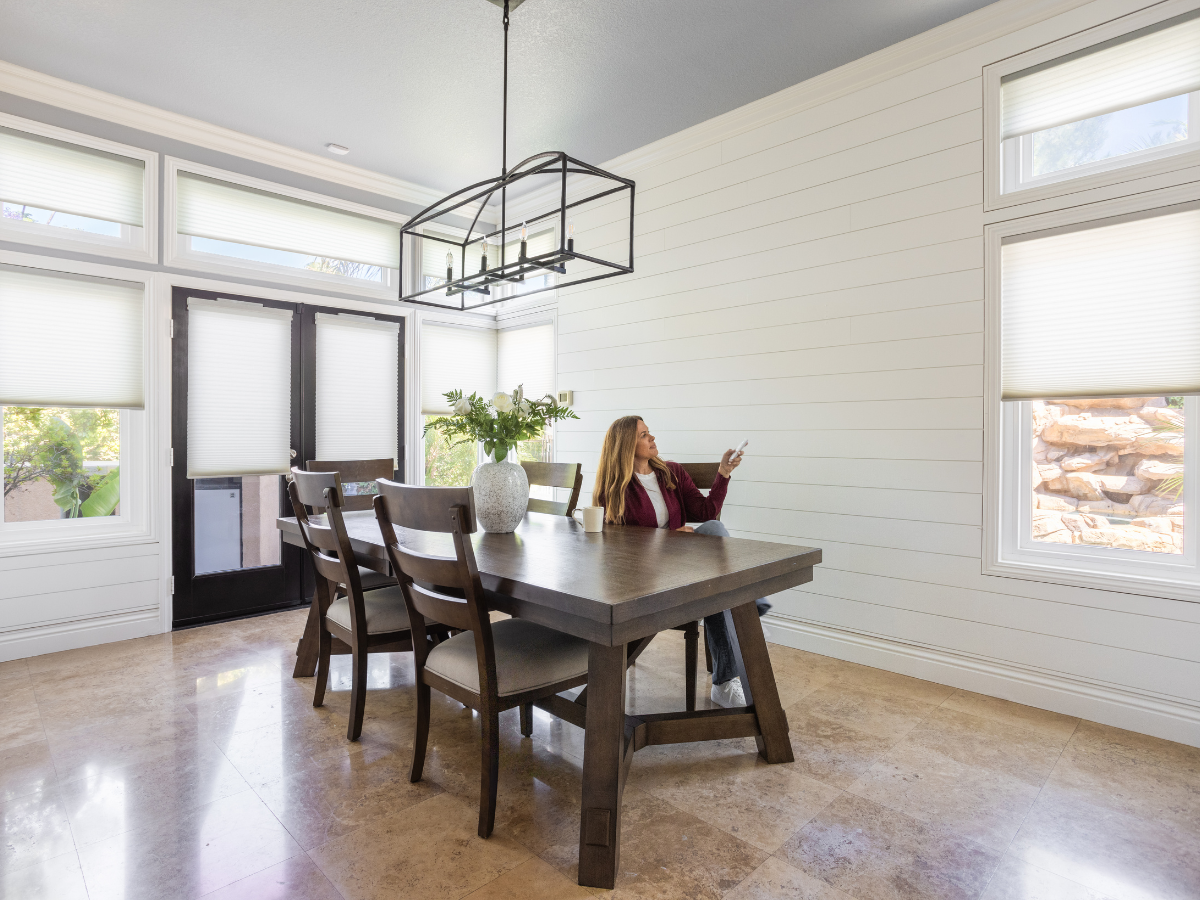 Motorized cellular shades in dining room.