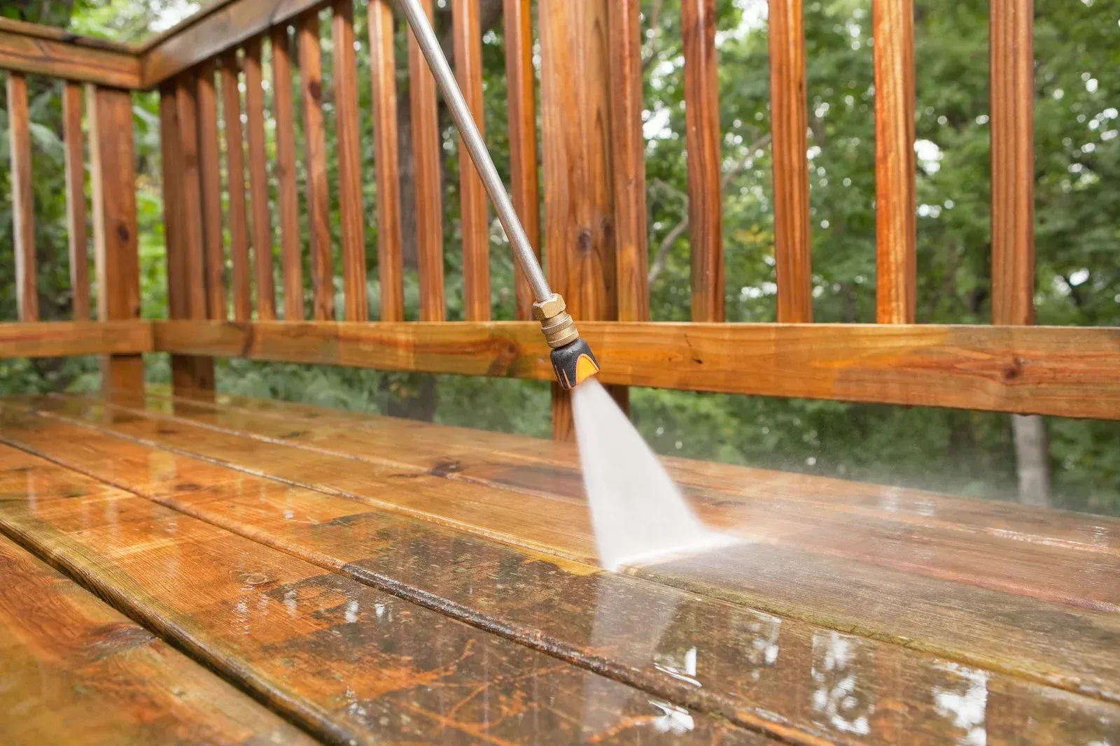 Pressure washing restores a wooden deck by removing dirt, mildew, algae, and weathering, enhancing t 