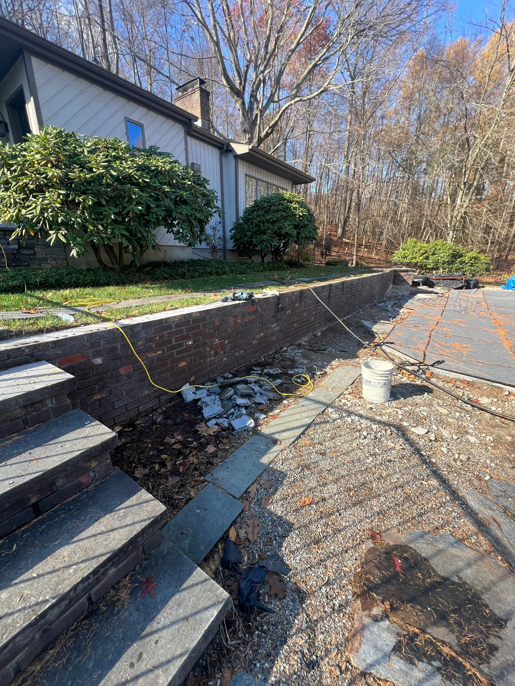 Removing and releveling bluestone wall tops - Masonry Repair project by General Masonry LLC.
