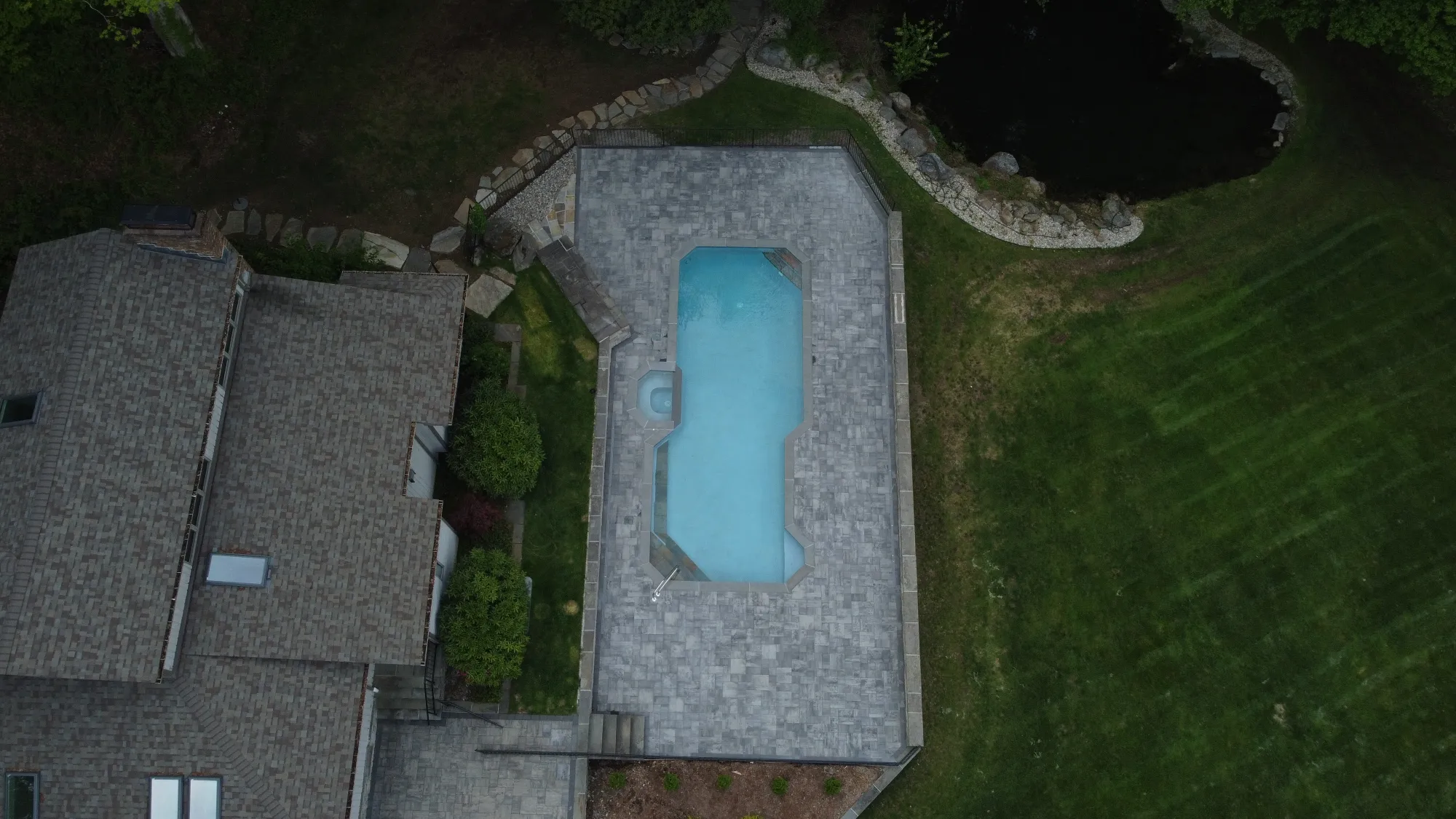 Aerial view of a full backyard pool deck transformation - Paver Pool Decks project by General Masonry LLC.