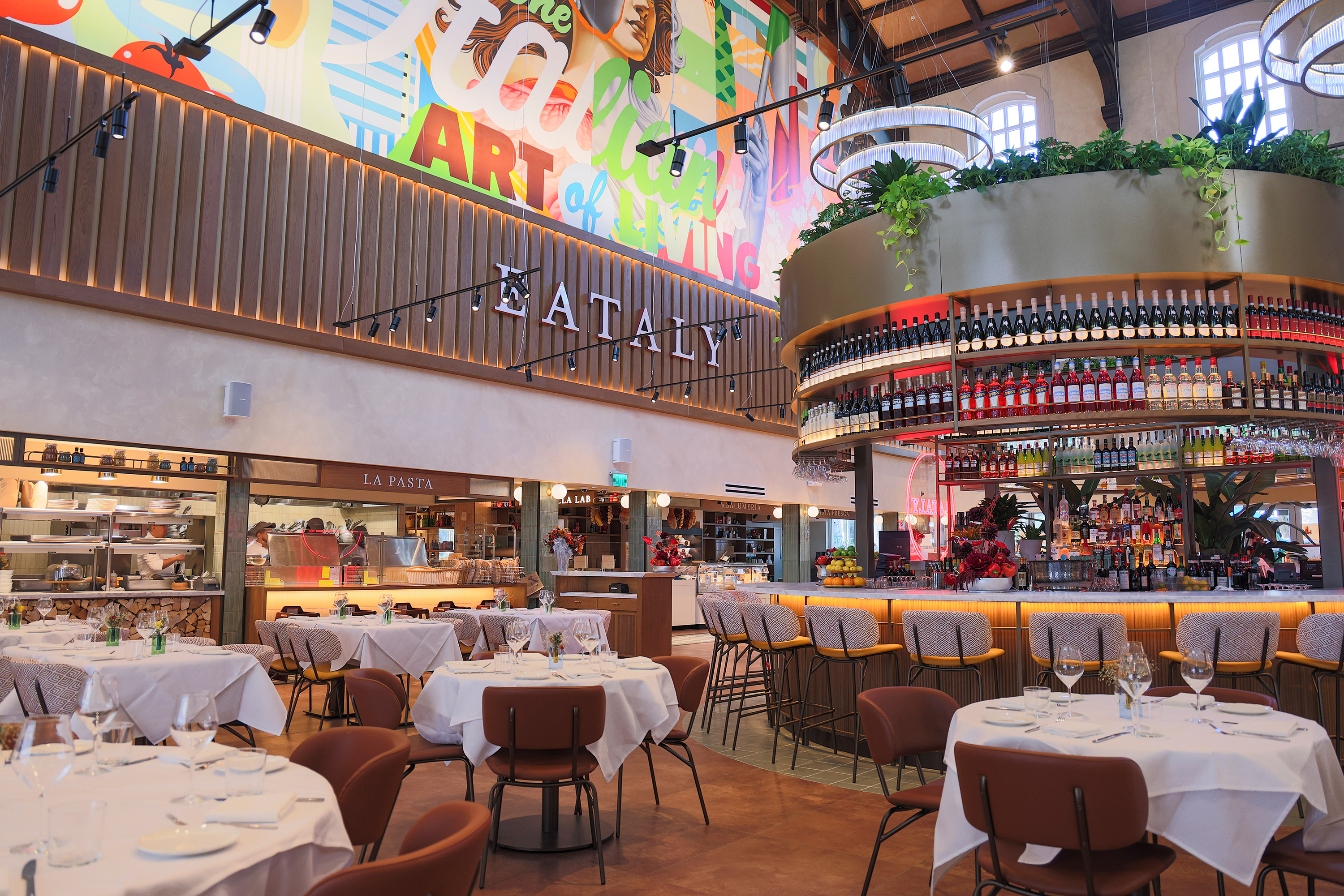 Elegant Italian dining experience featuring an open kitchen and central bar. 