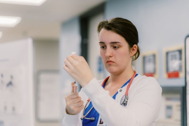 MUSC Health care team member preparing a flu vaccine in a clinic.
