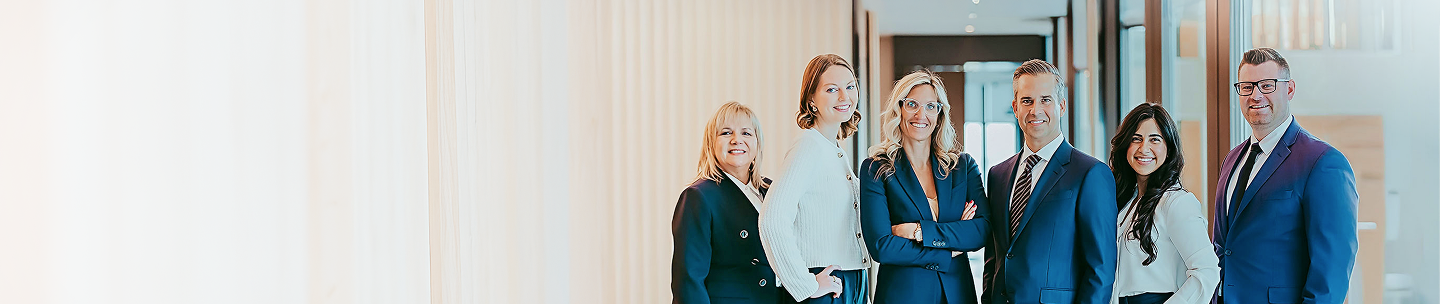 The Bogle Private Wealth Group team standing side by side in their office.