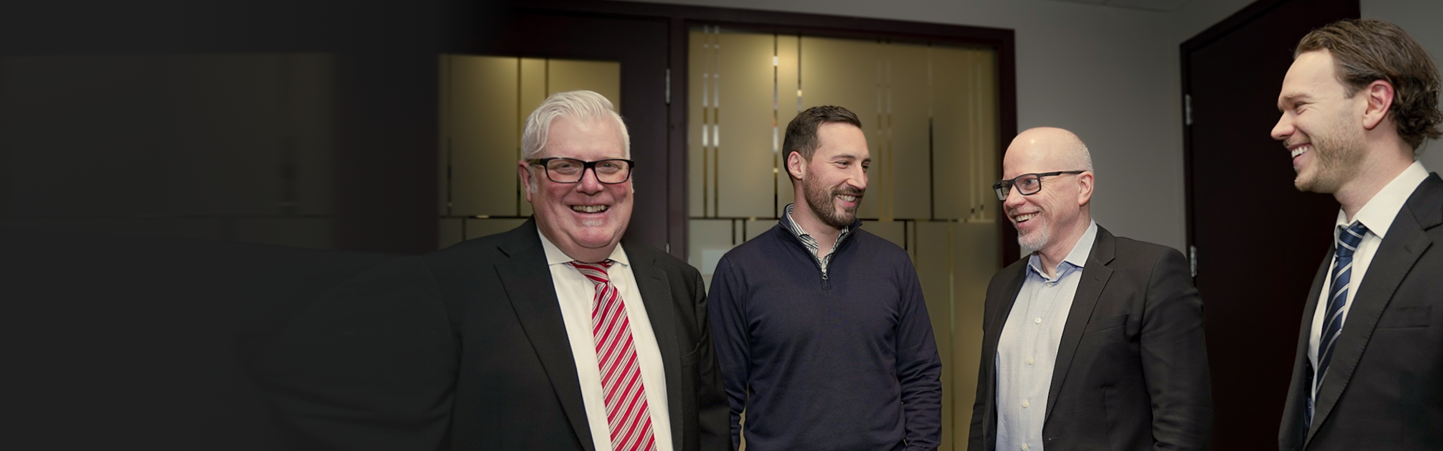 Greg Thompson and Rob Smith smiling alongside partners Dustin Rallo and James Kopp.