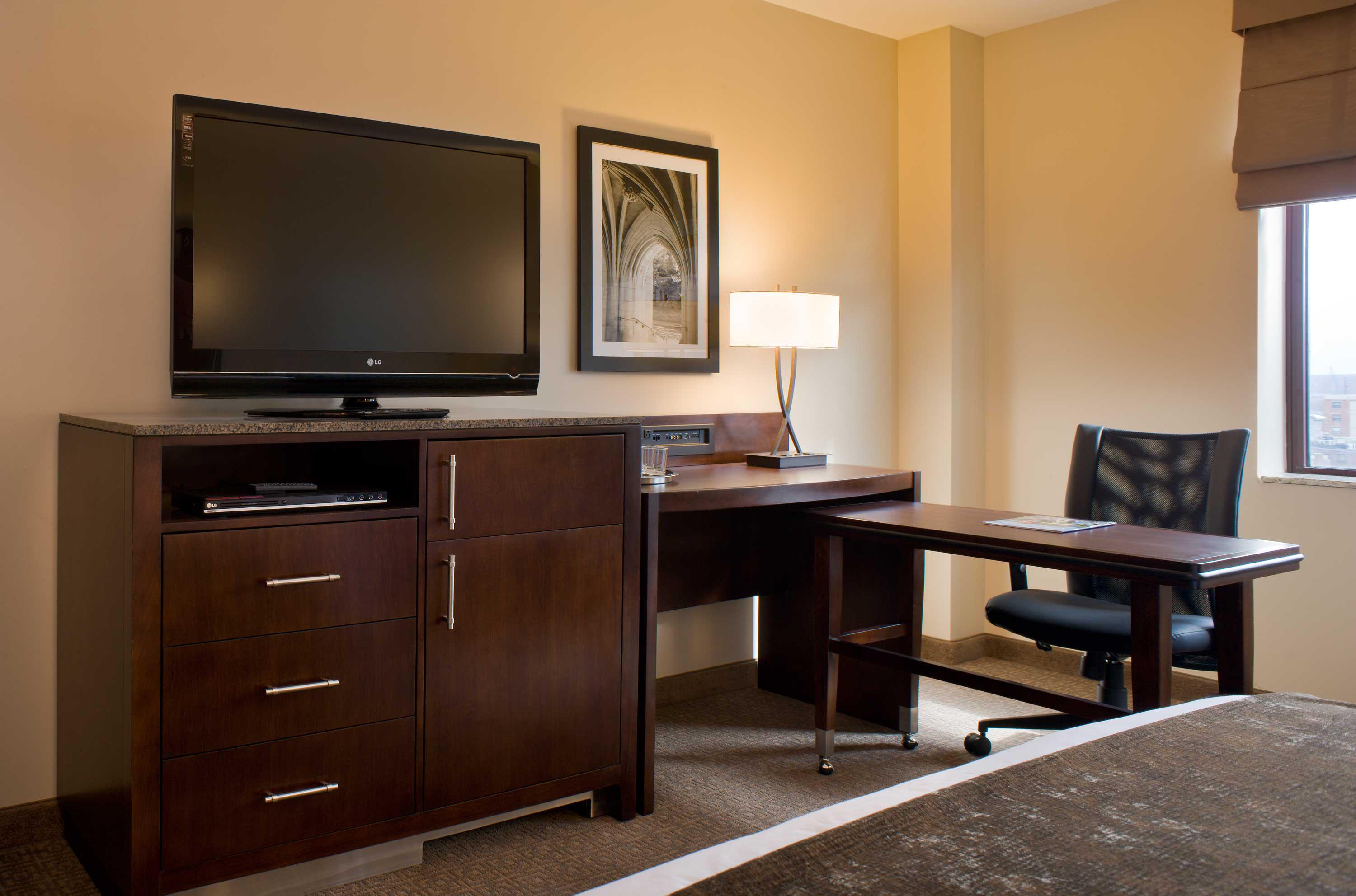 Enhanced work desk area in our New Haven Hotel guestrooms, including mini-fridge and laptop safe.