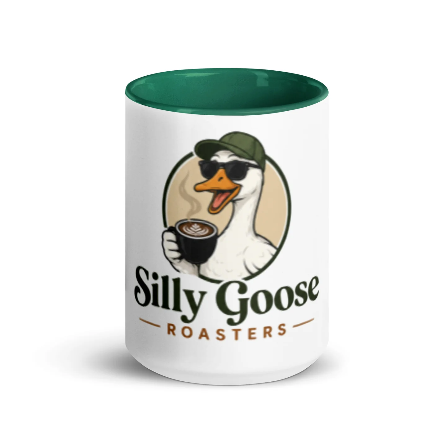 A white mug with a green interior features a humorous illustration of a goose wearing a baseball cap and sunglasses, holding a cup of coffee with latte art. The text "Silly Goose - ROASTERS" is printed below the illustration.