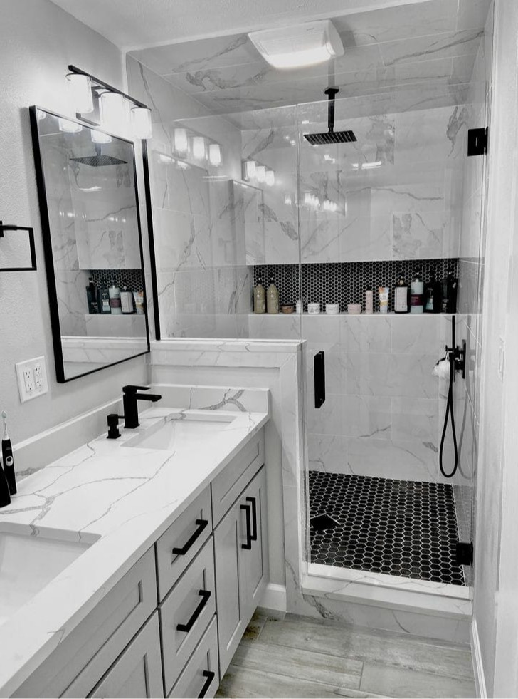 Residential bathroom remodel with tile flooring, updated vanity, and clean modern finishes by Elevate Remodels serving Montgomery County, MD.