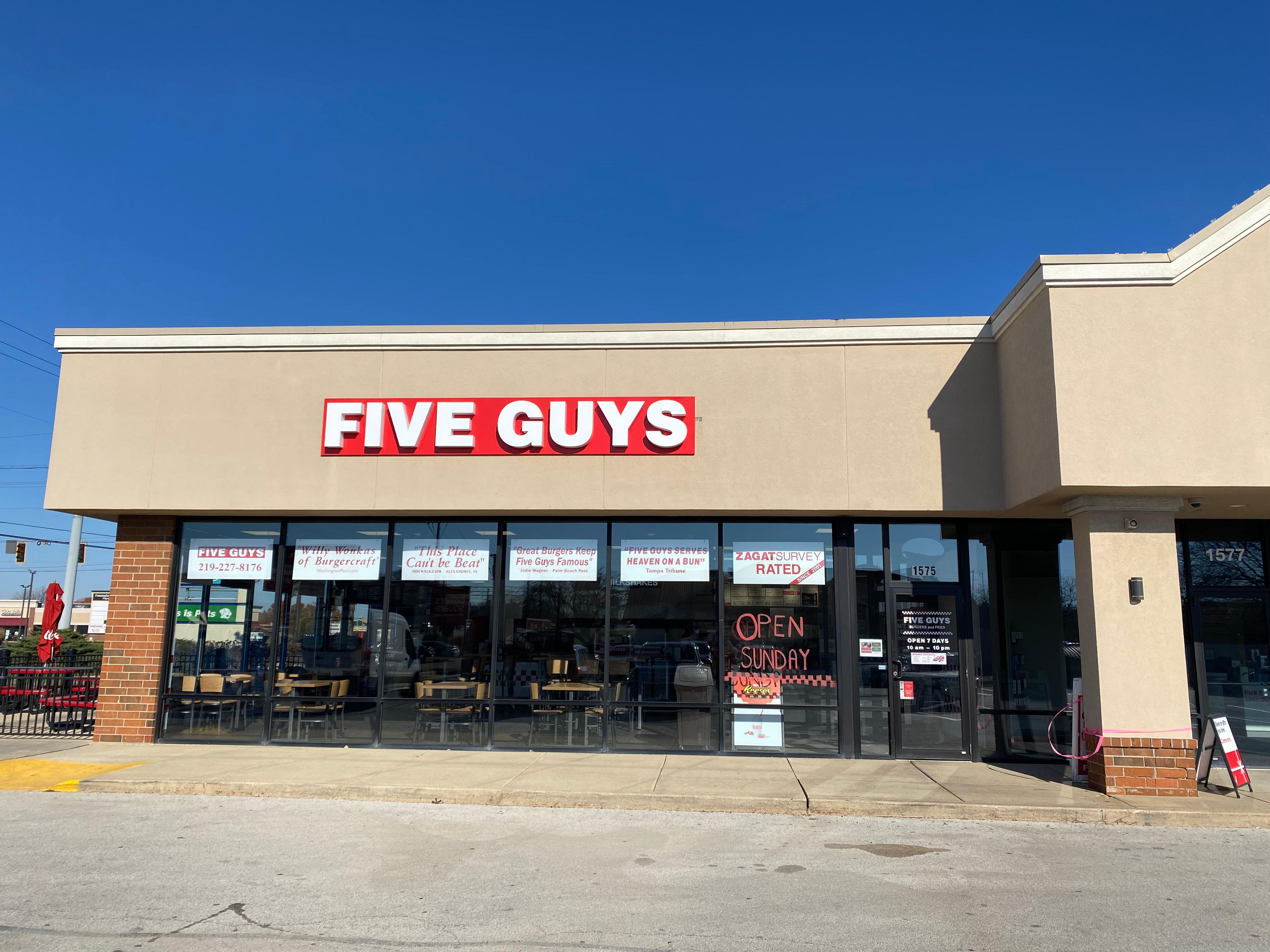 Exterior photograph of the entrance to the Five Guys restaurant at 1575 US Hwy 41 in Schererville, Indiana.