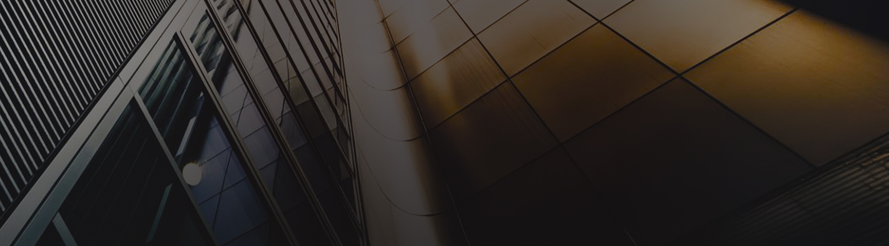 Close up, abstract view of a modern office building pictured from below.