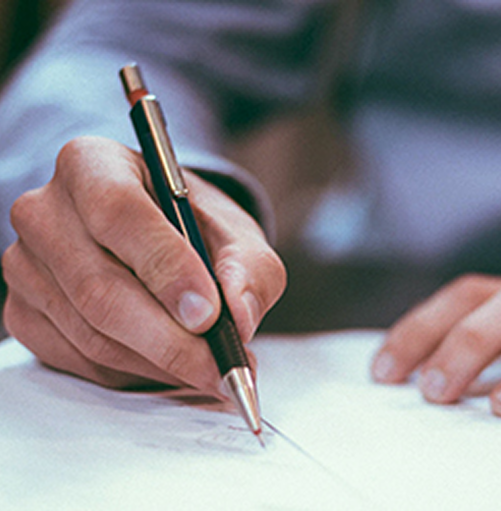 Close up of a man combing through paperwork.