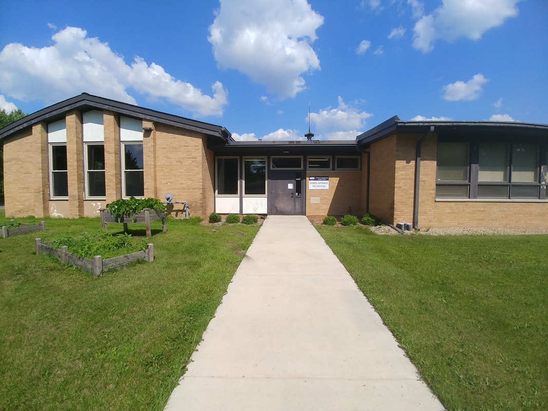 The main entrance to Progeny Academy welcomes students and families to a tuition-free public charter school dedicated to academic excellence and student achievement. Located in Brooklyn Center, Minnesota, the school serves grades K-8 with a rigorous educational program focused on leadership, science, technology, and personal growth.
