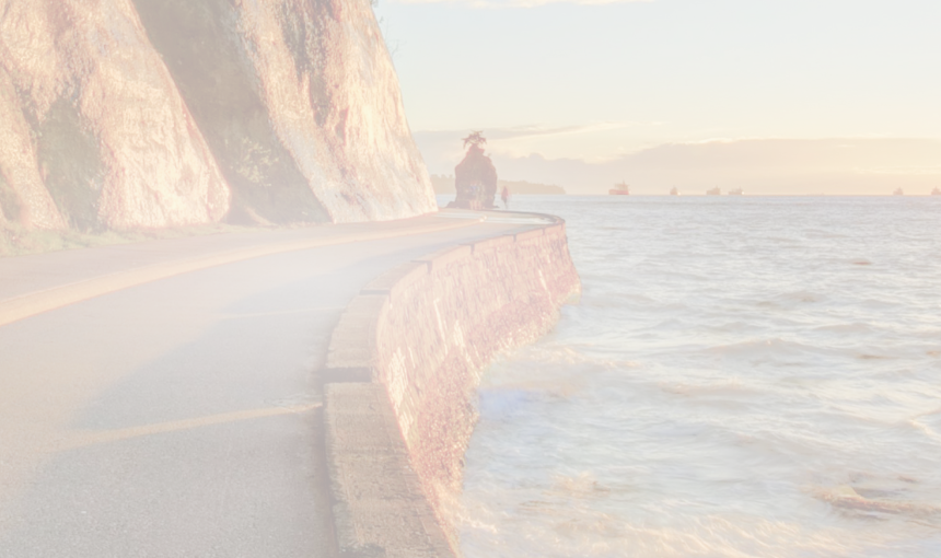 The Vancouver seawall at sunset, with the sun glistening off the water.