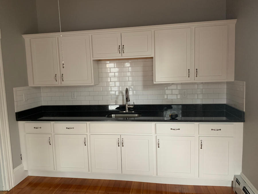 Our handyman installed cabinets, bald granite countertop, and white subway time back splash for this property in Salem, MA.