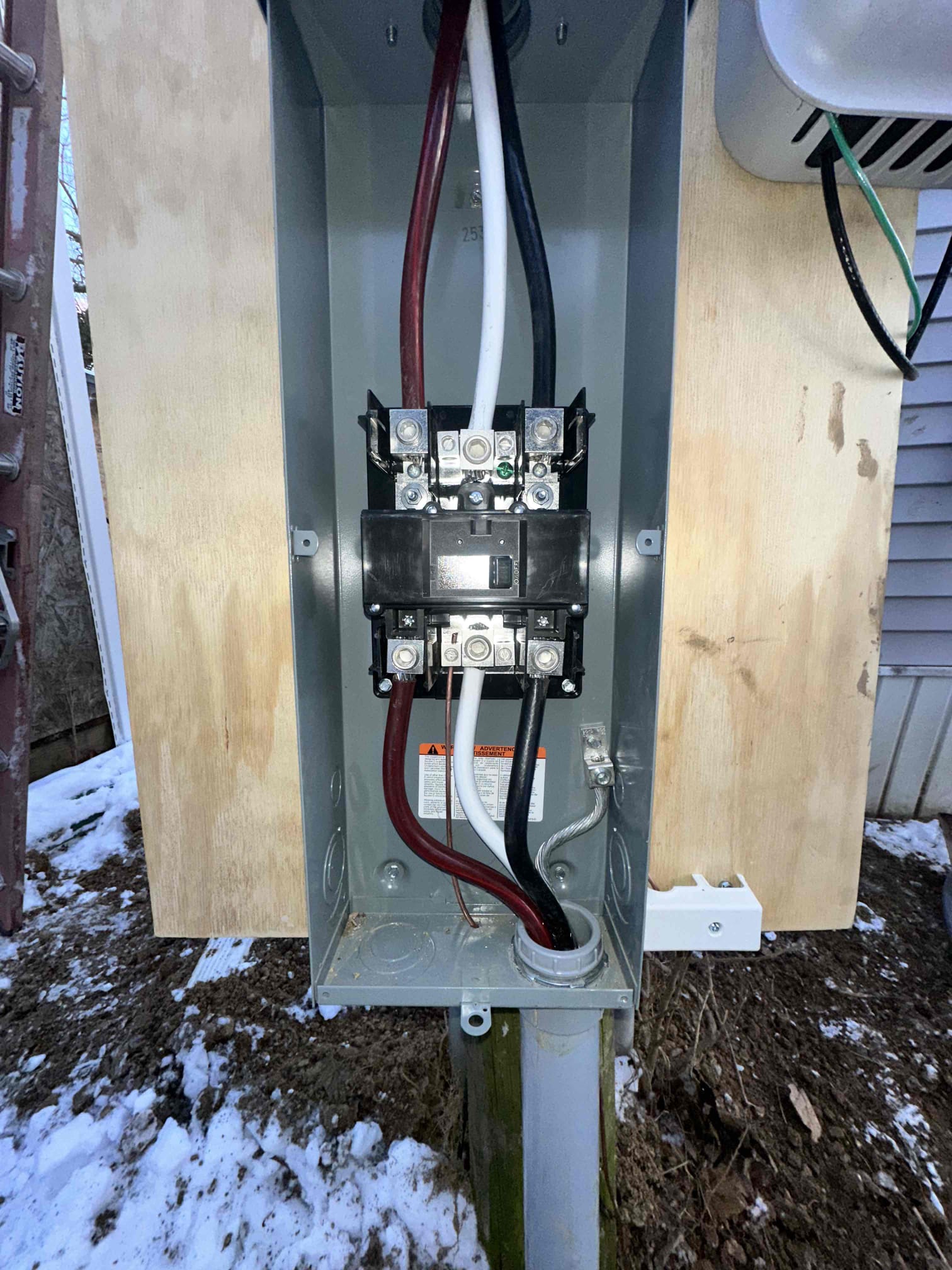 Thomas Edison Electric wired this exterior main disconnect at a Lebanon, PA home during a service upgrade. The heavy-gauge service entrance cables are properly terminated to the lugs, with the panel mounted on a treated plywood backer for a secure installation.