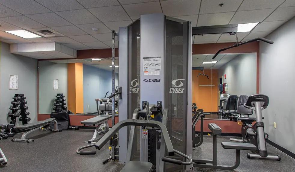 Fitness center featuring cardio equipment and free weights