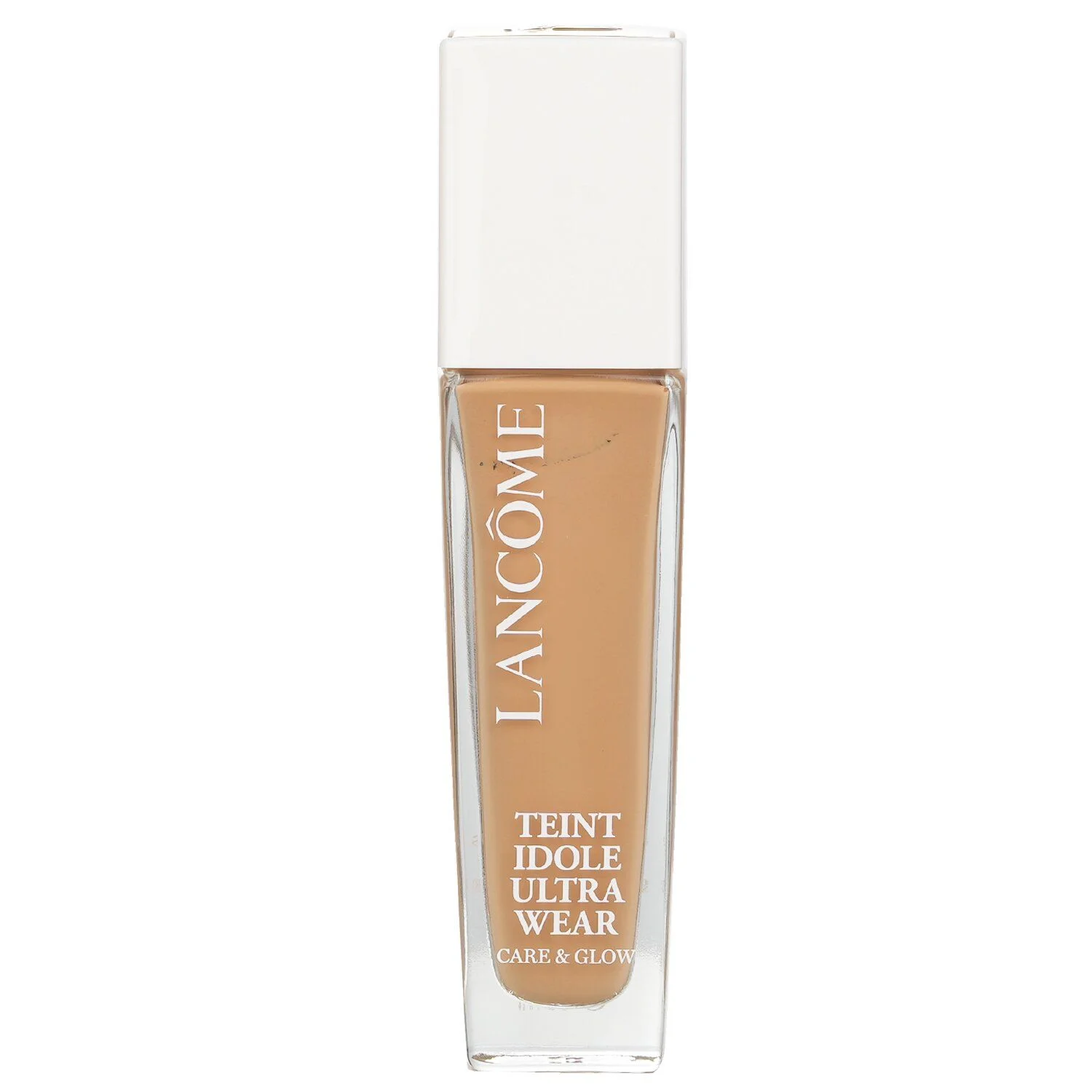 A bottle of Lanc&ocirc;me Teint Id&ocirc;le Ultra Wear foundation in a warm, medium-tan shade with a white cap. The bottle is made of clear glass and is rectangular with slightly rounded edges. The brand name "LANCOME" is printed vertically in white text on the side of the bottle, along with "TEINT IDOLE ULTRA WEAR" and "CARE & GLOW" printed horizontally below it.