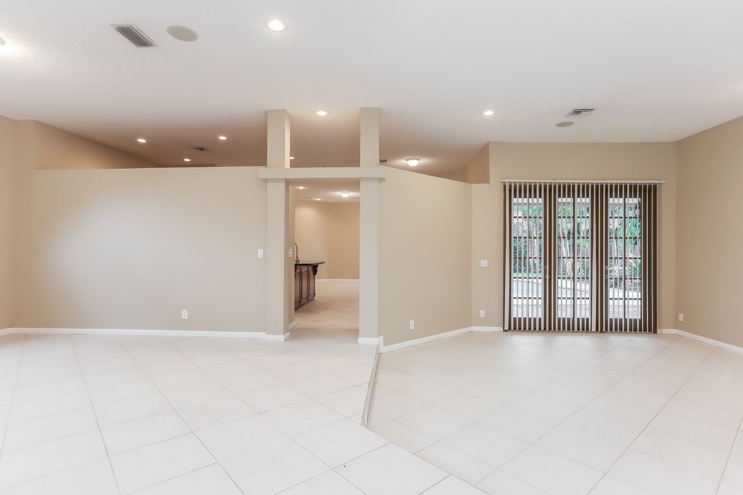 Spacious living area with tile and recessed lighting at Invitation Homes South Florida.