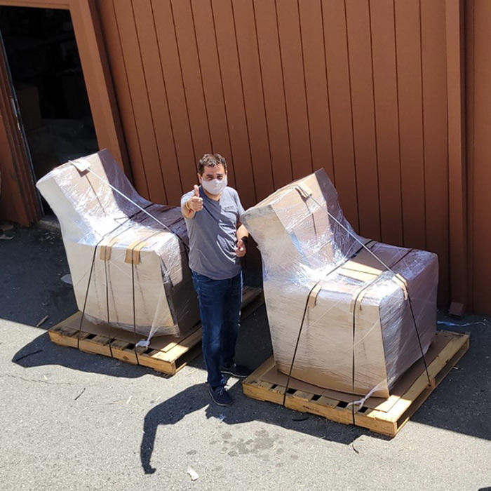 Associate standing next to packed freight items