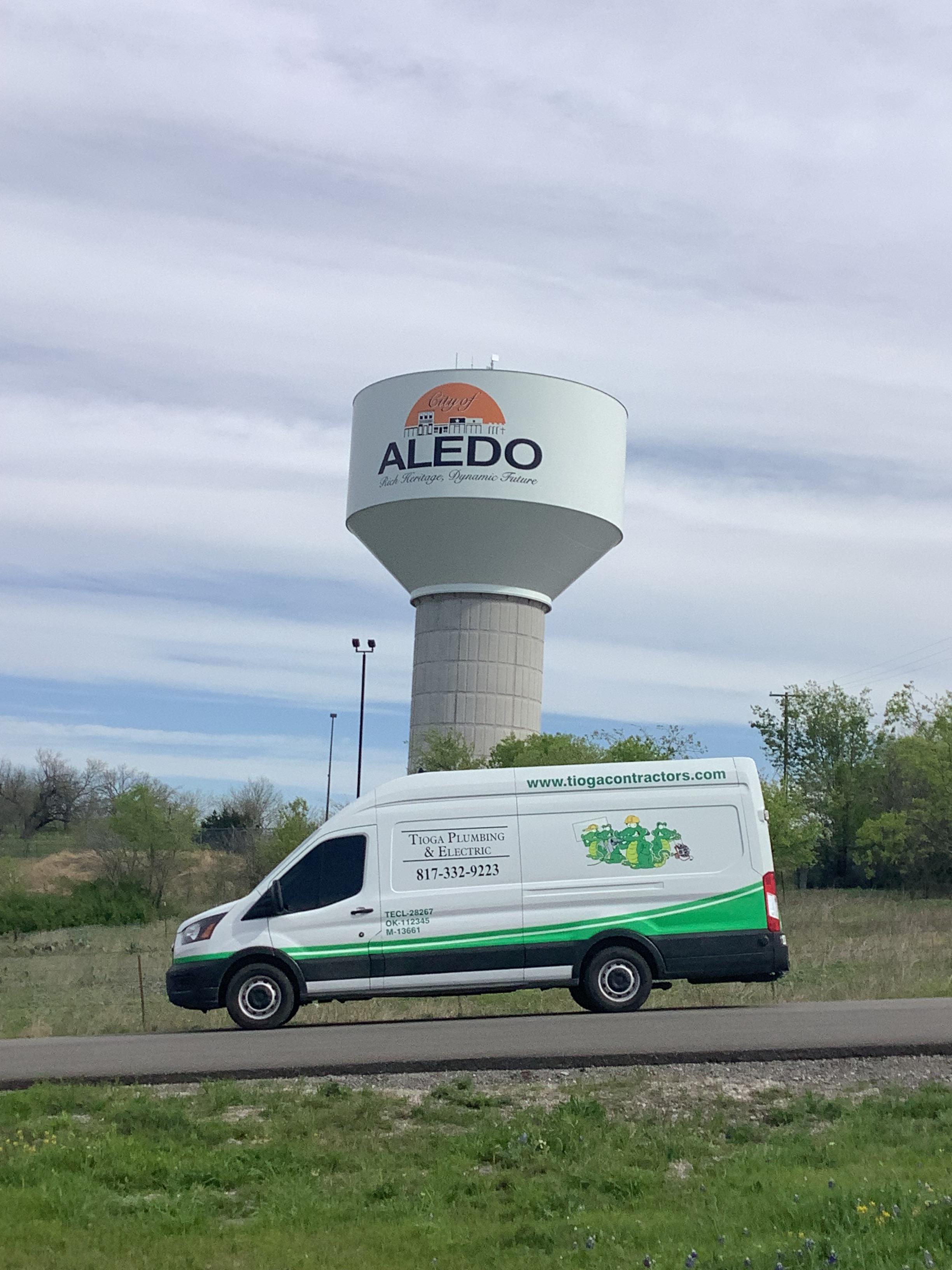 One of the Tioga Plumbing & Electric vans in Aledo Texas in front of the Aledo Water Tower.