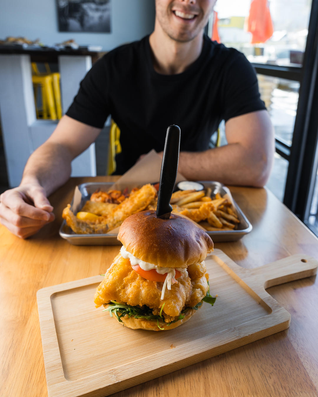 OUR LEGENDARY FISH SANDWICH - Joey's Famous Fish, lime slaw, tomato, mixed greens, chipotle aioli an Joey's Fish Shack Camrose (780)673-0164