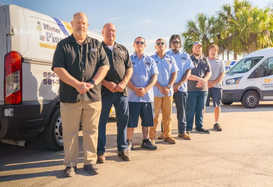 The Mister Plumber Team standing outside in front of their van. 