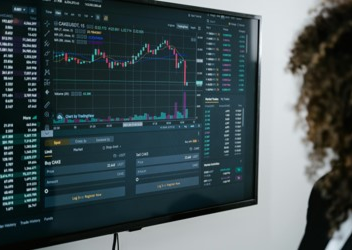 A computer screen displaying a graph tracking stocks.