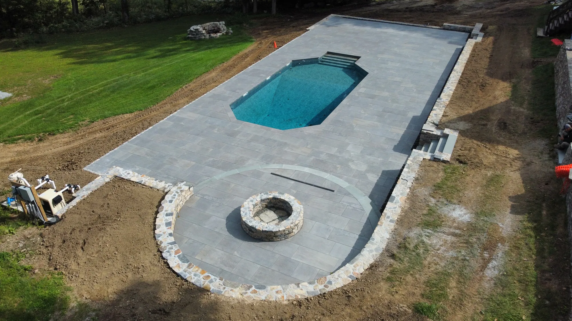 Wide view of a paver pool deck installation - Paver Pool Decks project by General Masonry LLC.