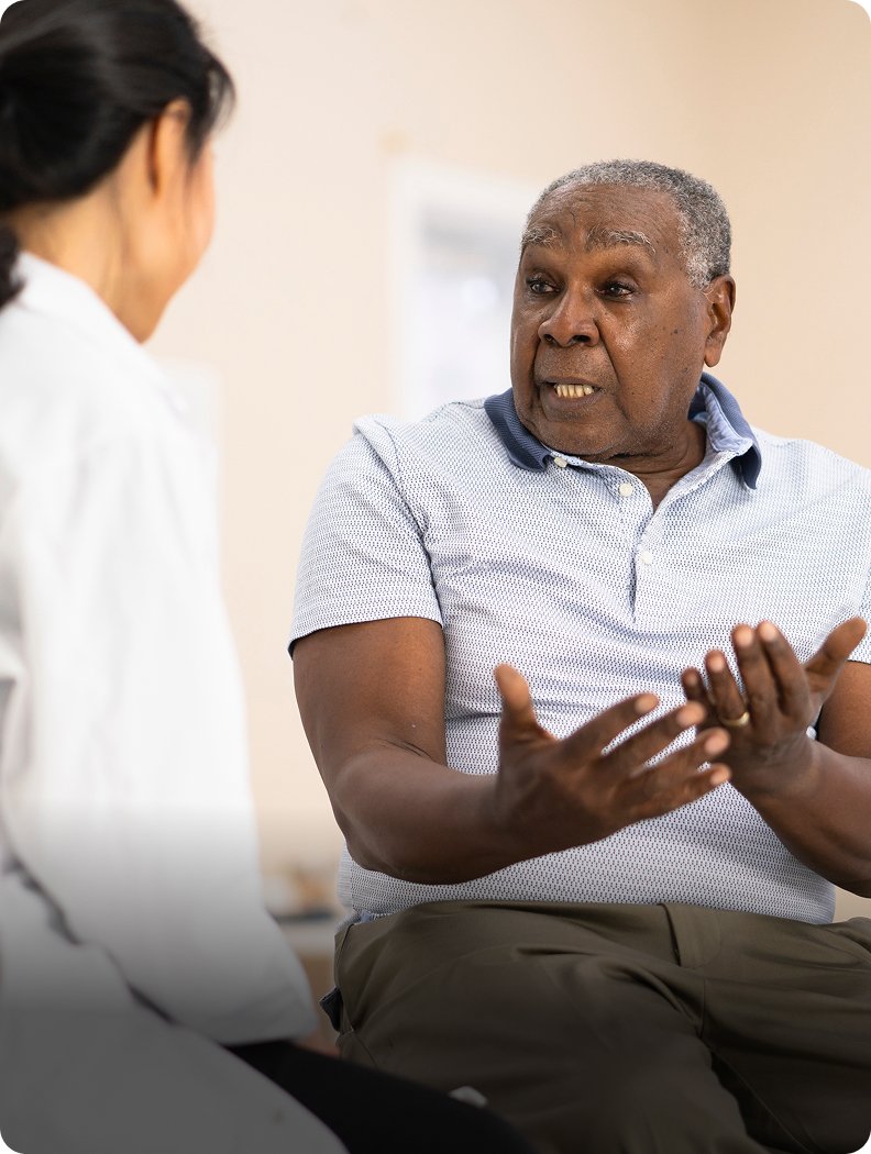 A man discussing varicocele embolization with a doctor at American Access Care Brooklyn