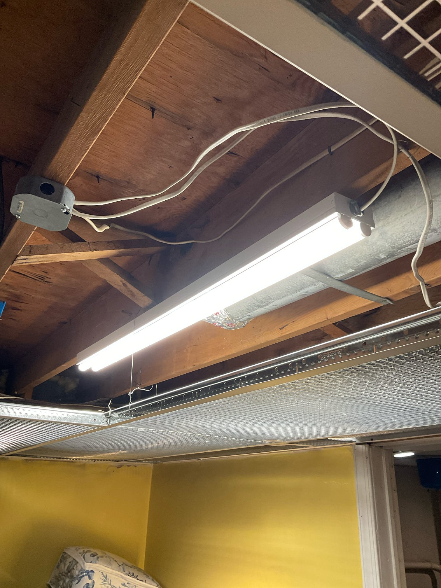 Thomas Edison Electric installed an LED strip light fixture in an unfinished basement in Southampton, PA. The bright, energy-efficient light is wired to a junction box on the ceiling joists, providing much-needed task lighting in the utility area.