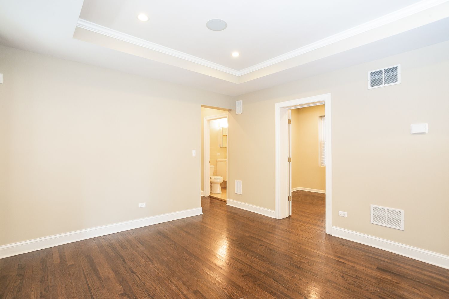 Spacious bedroom with hardwood floors at Invitation Homes Chicago.