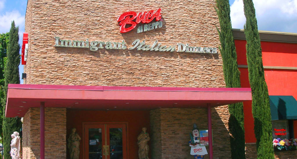 Buca di Beppo Roseville front brick exterior with a Buca sign and a red cover.