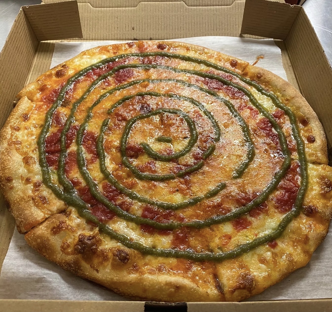 Marinara and vodka sauce, shredded mozzarella, sliced fior di latte fresh mozzarella and pesto drizzle.
