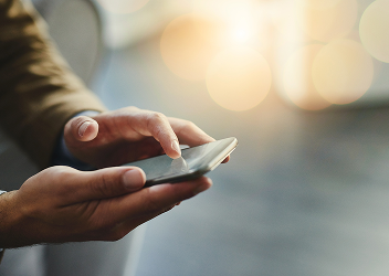 A close-up of a client on their cellphone.