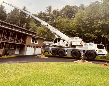 Martel Crane Service & Tree Removal setup in front of this house in Groton, MA, to safely remove trees from the rear of the property.