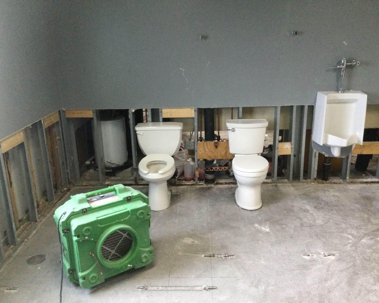 A commercial bathroom became flooded after severe weather in the area. We created some flood cuts to allow proper drying and air flow. Our industry-grade air mover is placed strategically for the best air flow possible.