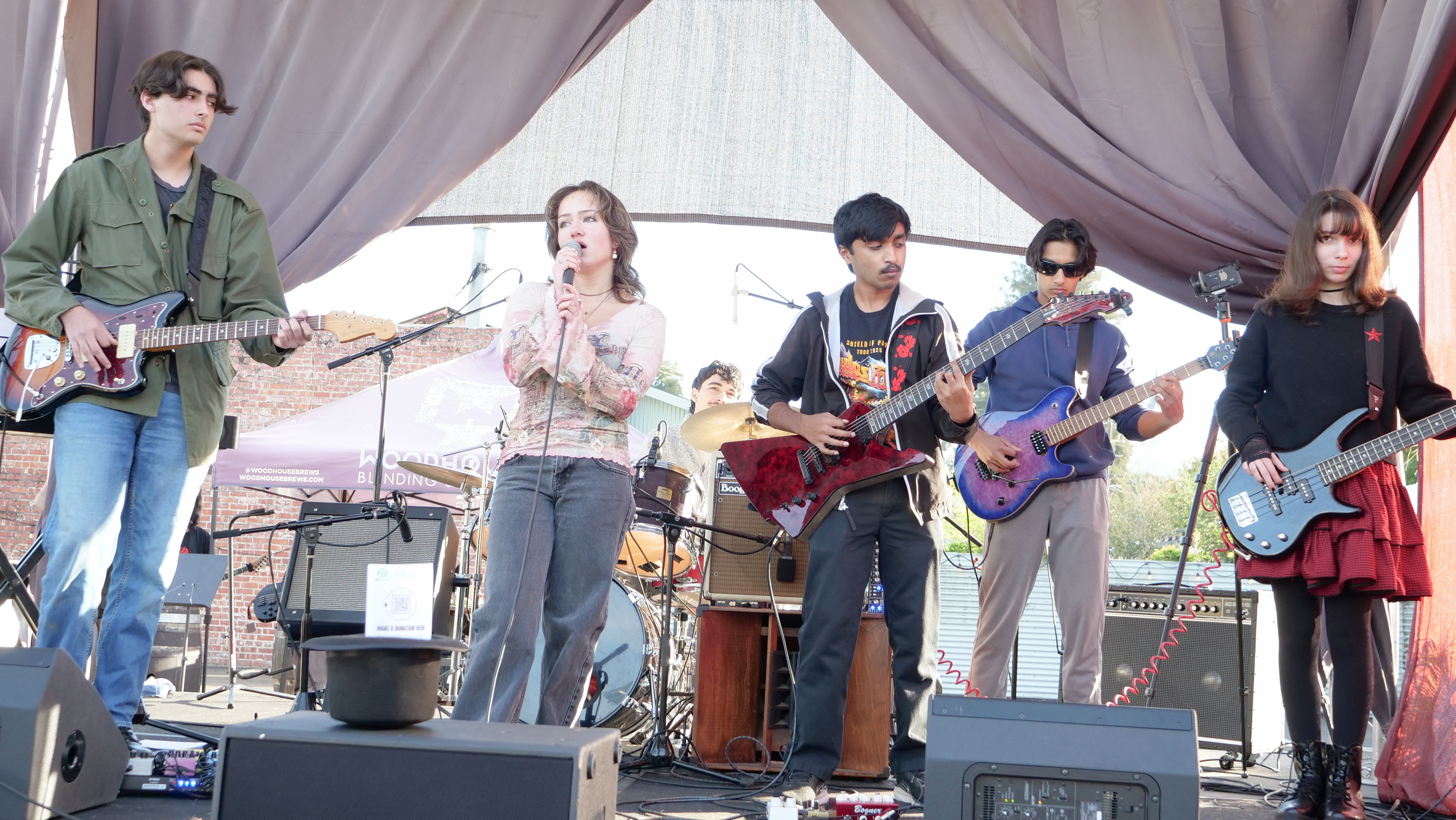 Student band performing together at a live concert event, highlighting collaborative music education and stage experience.
